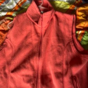 Pink fleece vest.